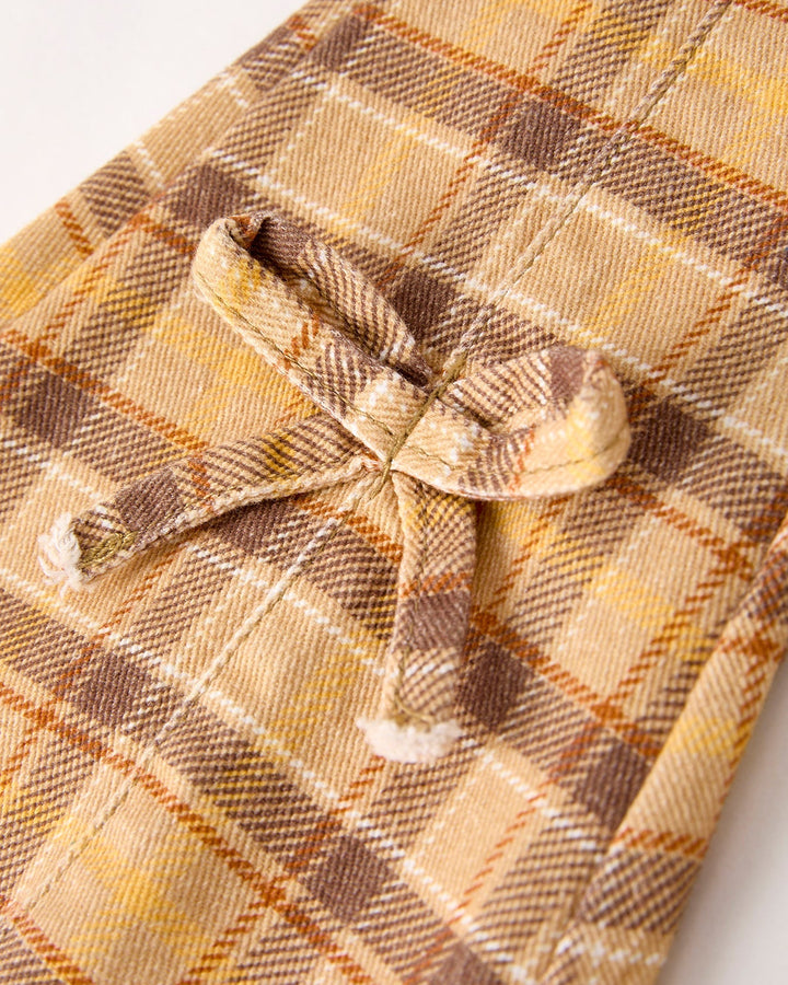 Plaid girls jeans detail: bow-tie tabs at front and stitched pocket, yellow-brown check
