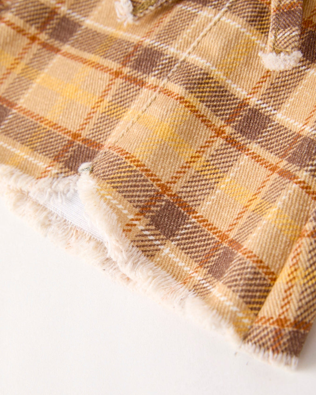 Plaid flared jeans hem with frayed trim in yellow-brown check fabric