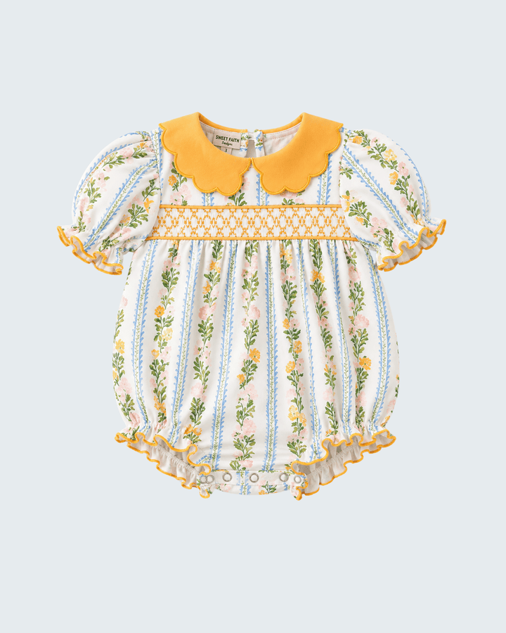Golden floral smocked romper with scalloped yellow collar and gathered short sleeves
