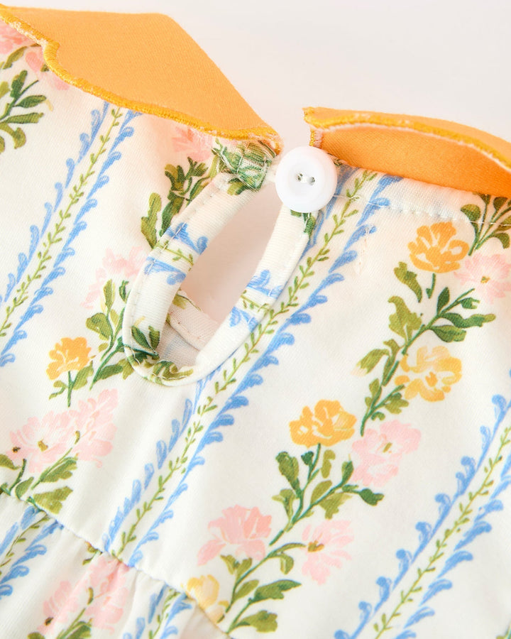 Floral stripe baby romper with orange scalloped neckline and white button placket.