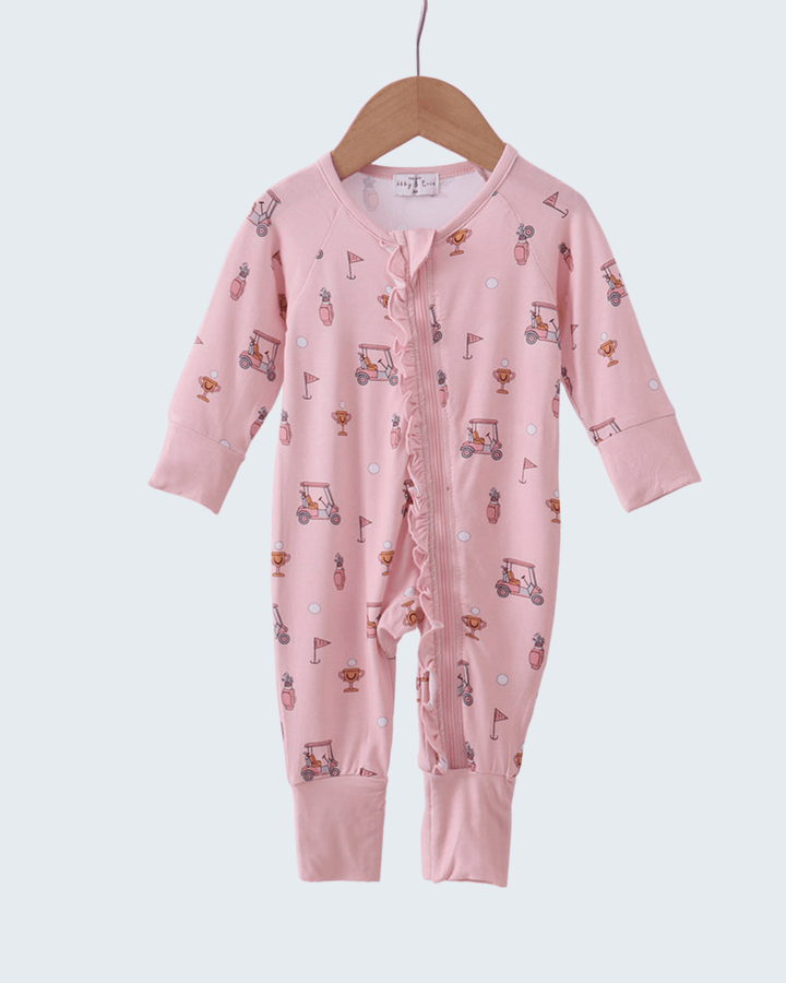 Pink baby onesie with vehicle pattern on a hanger against a white background