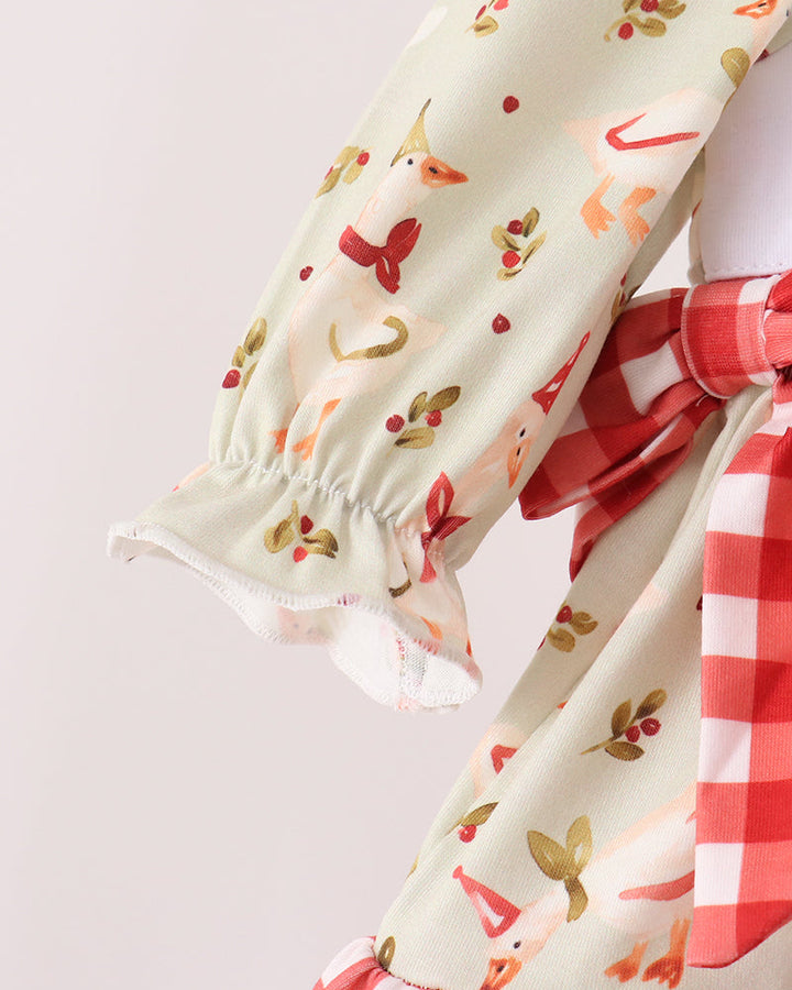 Cream long-sleeve ruffle top with red animal print and gathered elastic cuffs