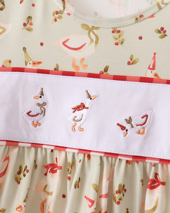 Cream waistband with stitched animal motifs and red-and-white ruffle skirt