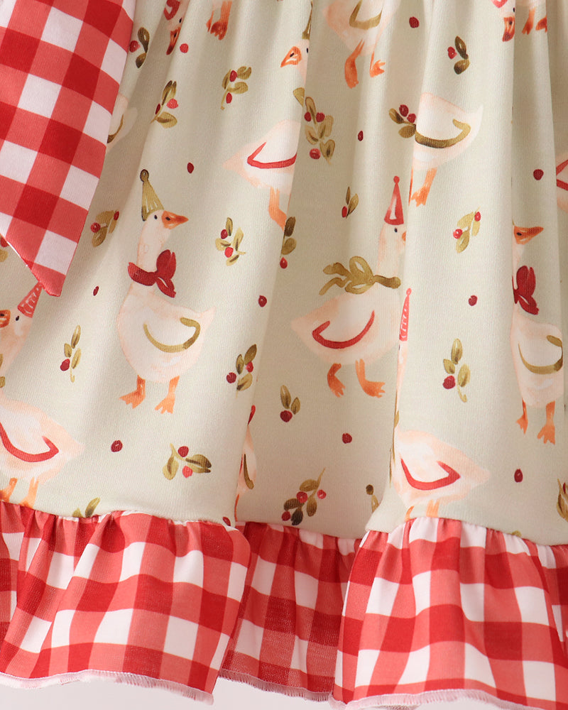 Cream ruffle top with red animal print and red gingham hem trim