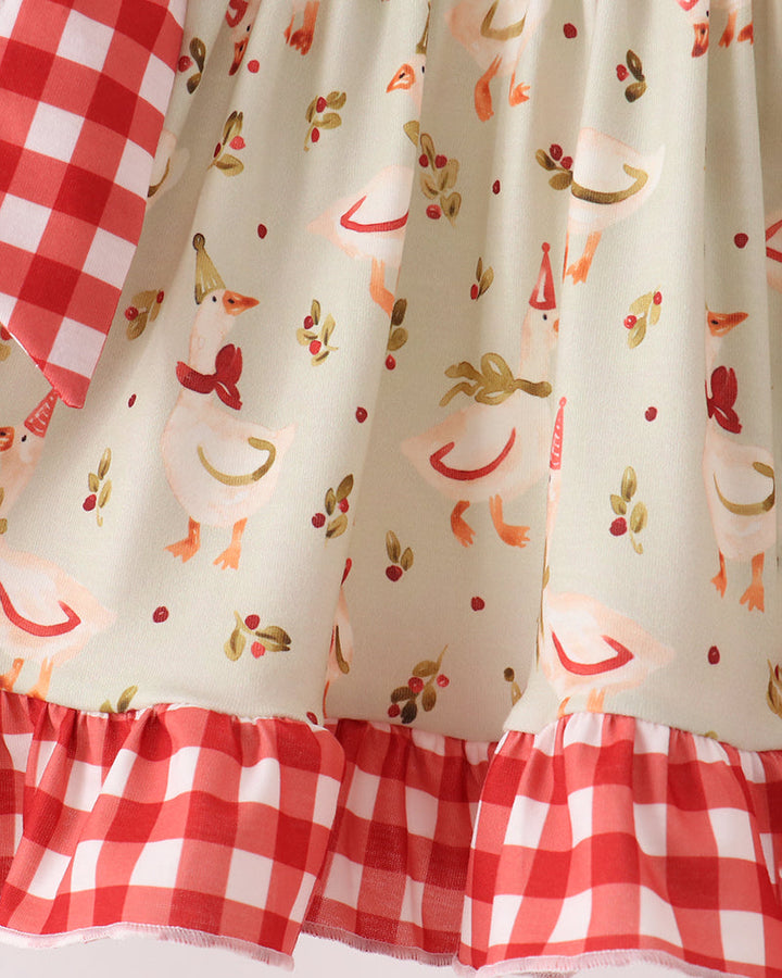 Cream ruffle top with red animal print and red gingham hem trim