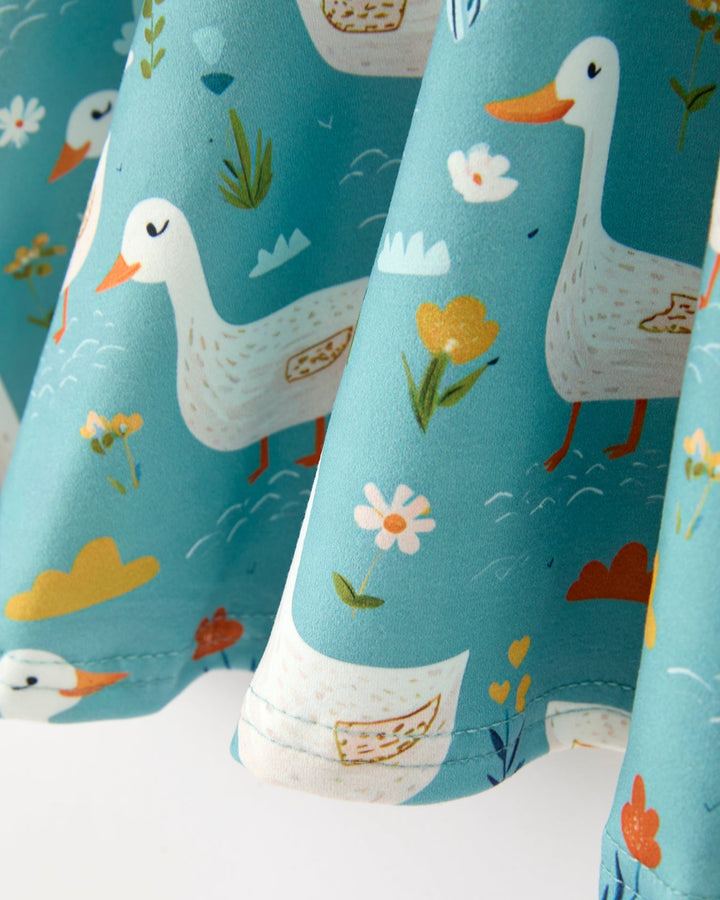 Dress with duck and floral design on a blue background