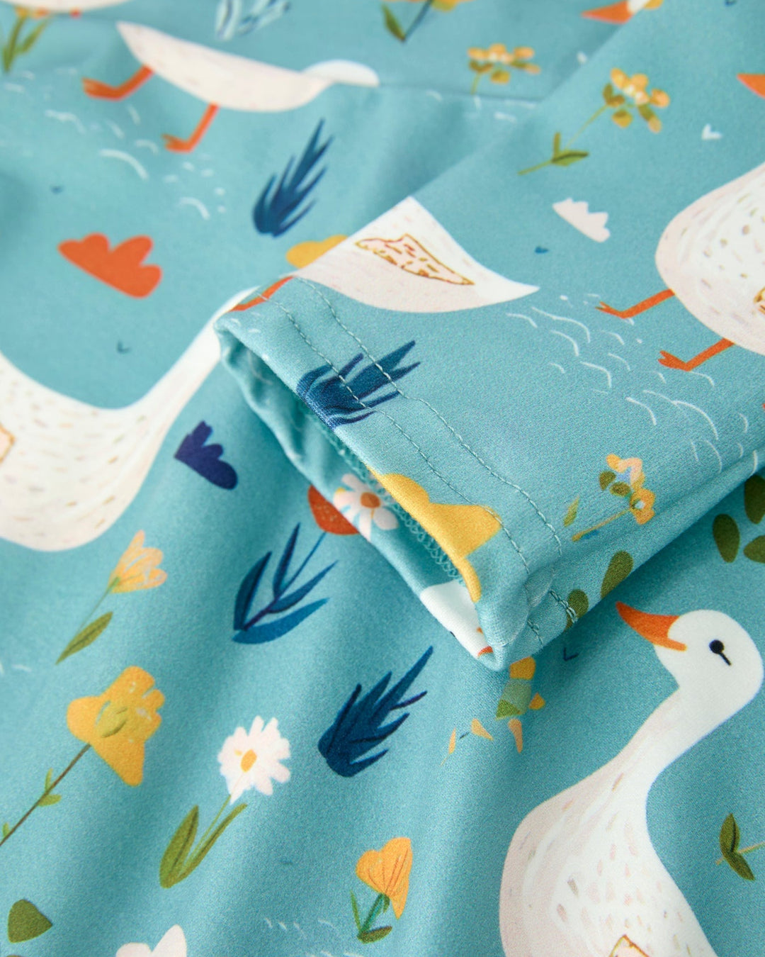 Folded fabric with goose and floral pattern on a blue background