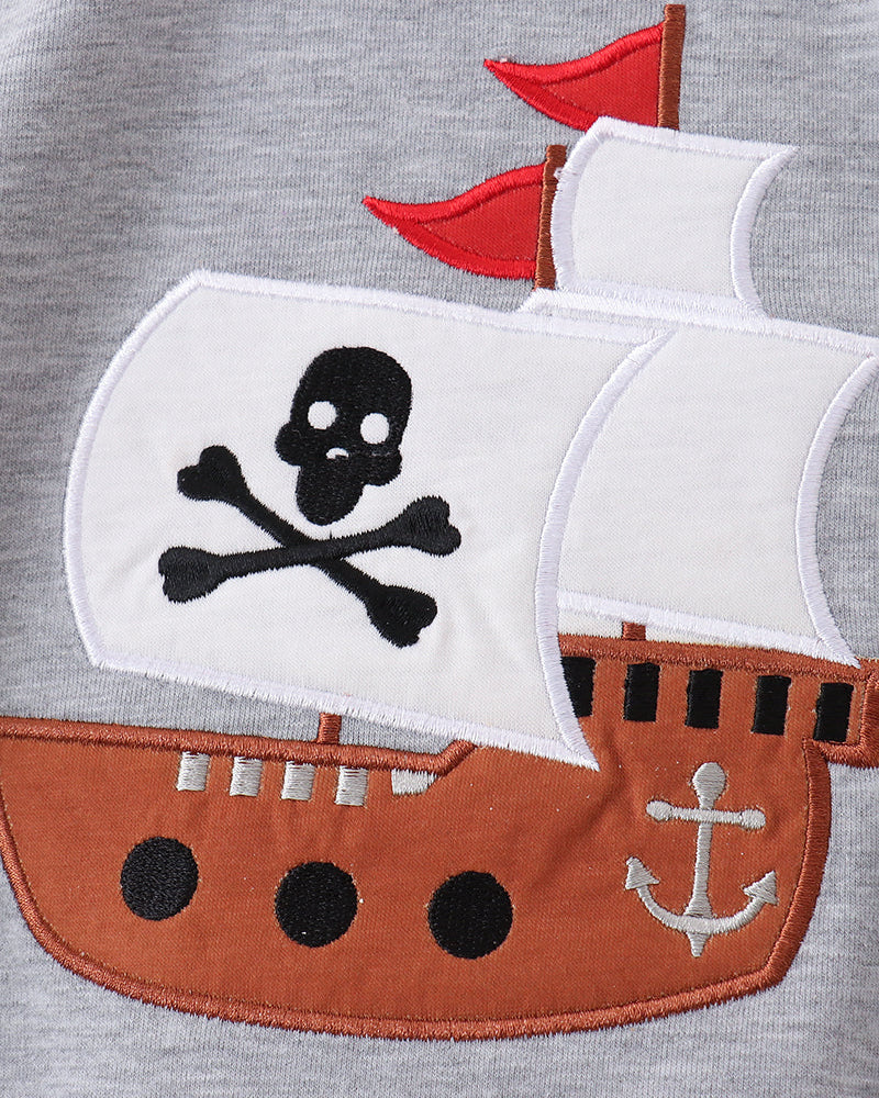 Gray shirt with a pirate ship design featuring a skull and crossbones on a white sail.