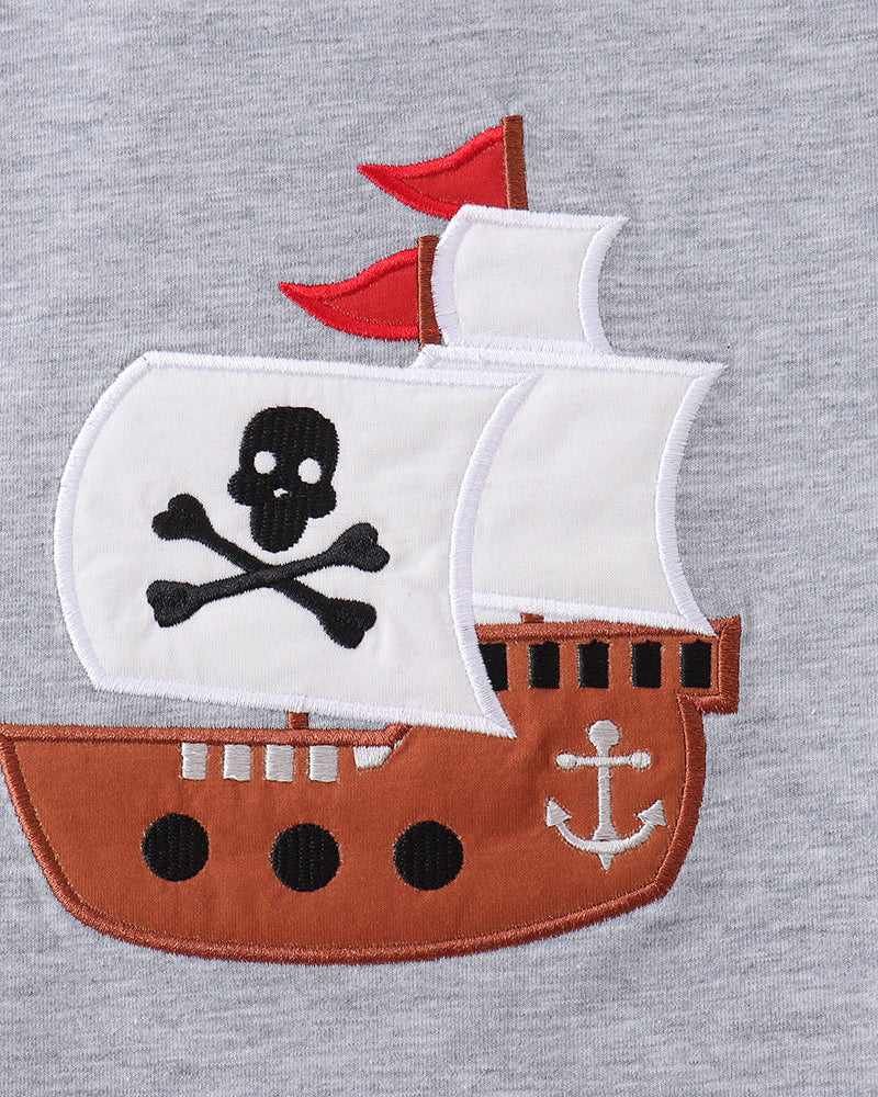 Pirate ship applique with skull and crossbones on a gray background