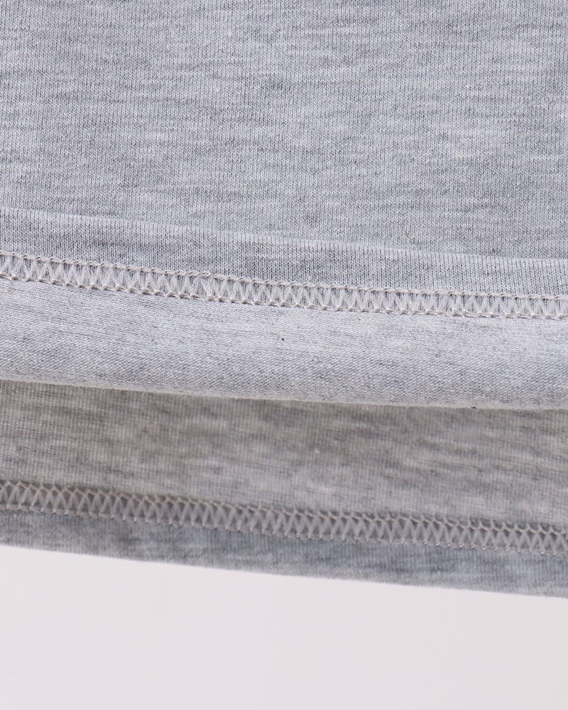 Close-up of a gray fabric with a brown circular patch on a white background
