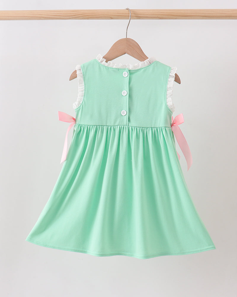 Mint green dress with buttons on a hanger against a white background
