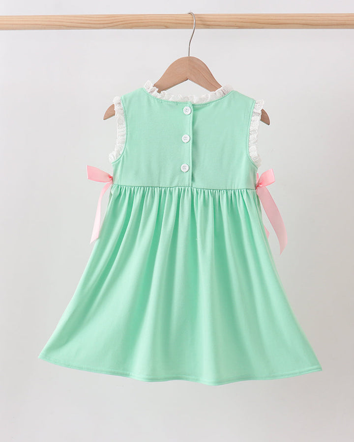 Mint green dress with buttons on a hanger against a white background