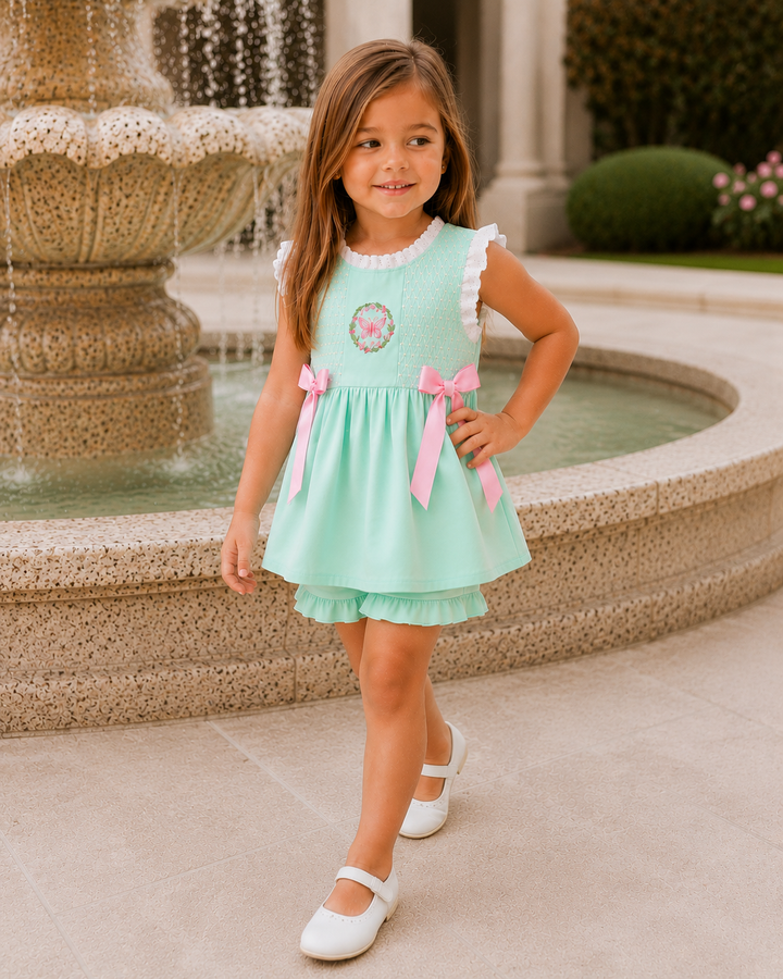 Young girl is walking away from a stone fountain.