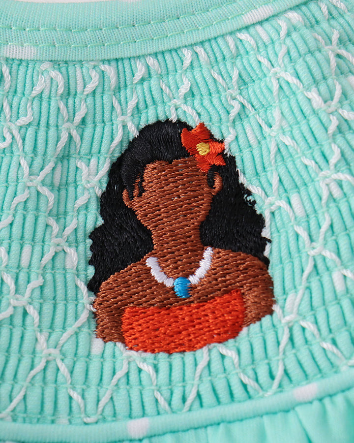 Embroidered character patch on mint smocked yoke
