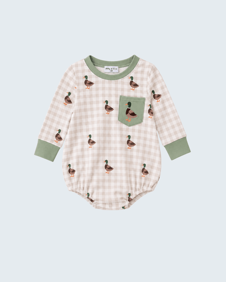 A baby long-sleeve bodysuit featuring a light beige and white gingham pattern, decorated with small green, brown, and orange mallard ducks. It has sage green trim on the collar, cuffs, and a matching chest pocket.
