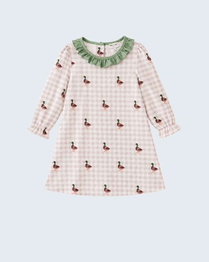 A long-sleeve baby dress with a pink and white gingham pattern, featuring a green ruffled collar and small green and pink duck prints, shown on a light gray background.