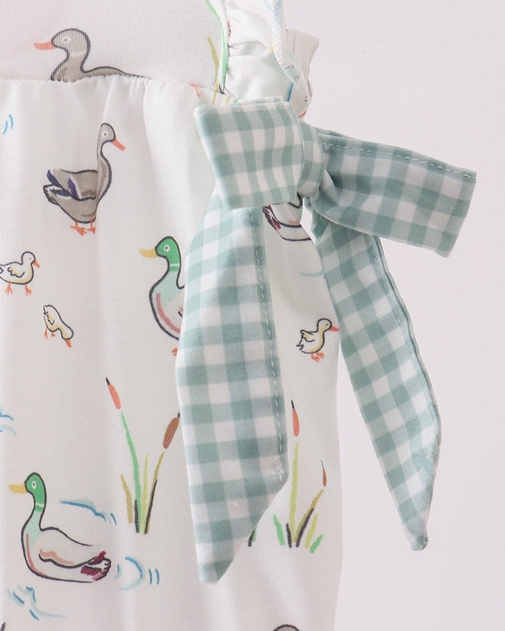 Fabric with duck illustrations and a checkered ribbon on a white background
