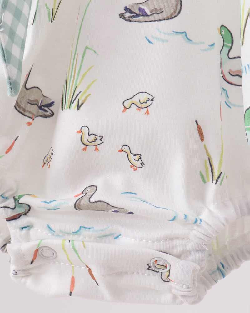 Baby onesie with duck pattern on a white background