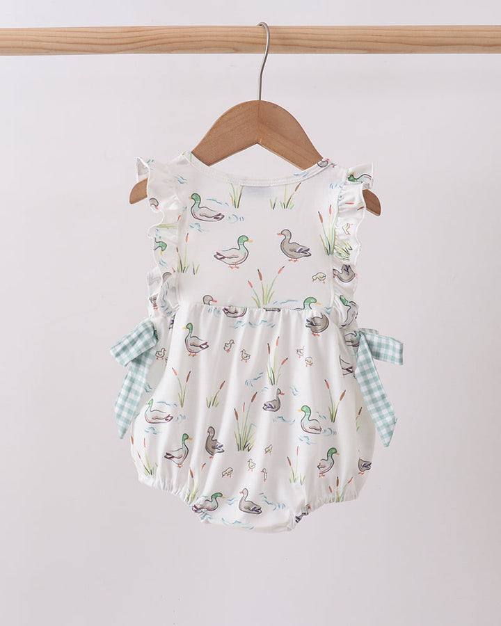 Baby romper with duck pattern on a hanger against a white background