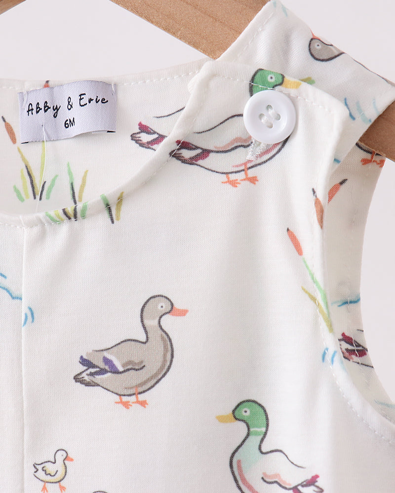 Baby romper with duck pattern on a wooden surface