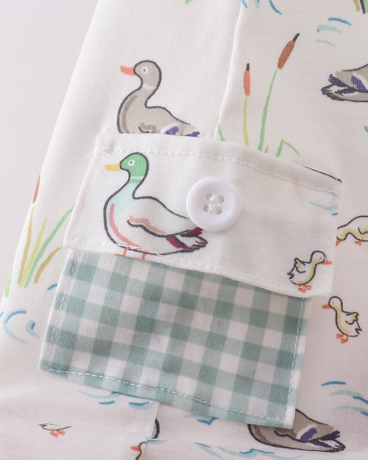 Fabric with duck pattern and a checkered pocket on a light background