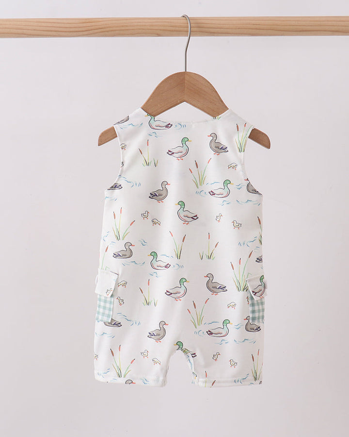 Baby romper with duck pattern on a hanger against a plain background
