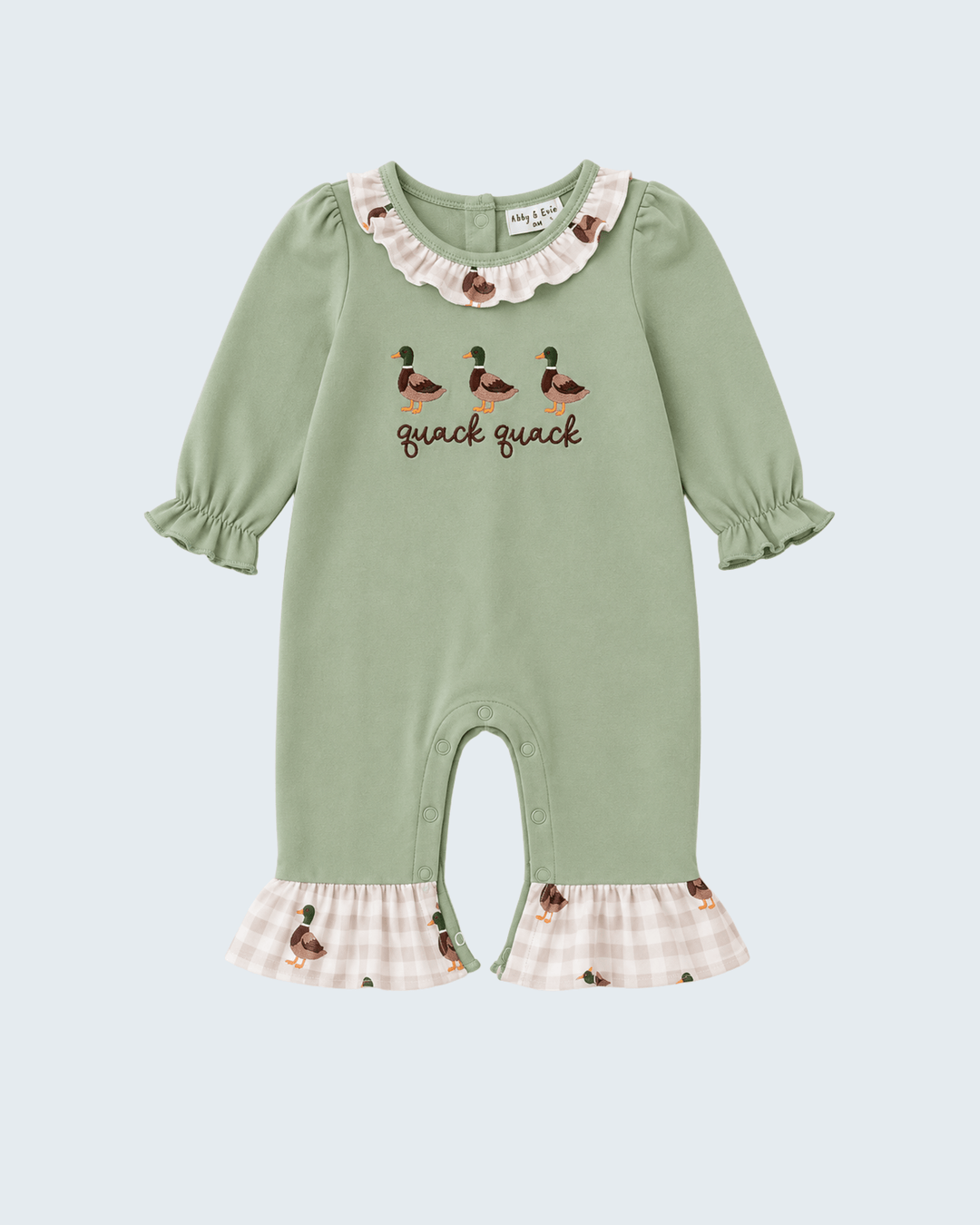 A sage green baby jumpsuit featuring duck illustrations and the text &