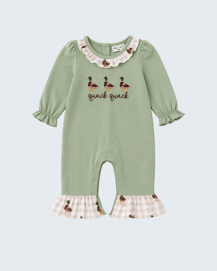 A sage green baby jumpsuit featuring duck illustrations and the text &
