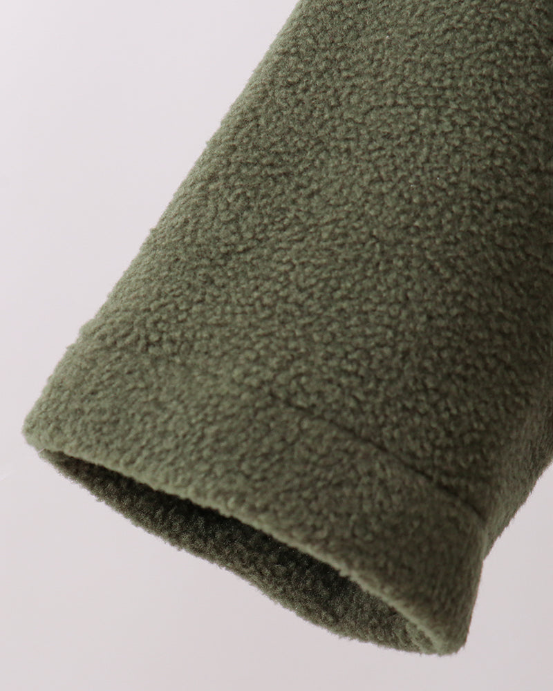 Dark green fleece coat sleeve hem with soft textured pile and ribbed cuff
