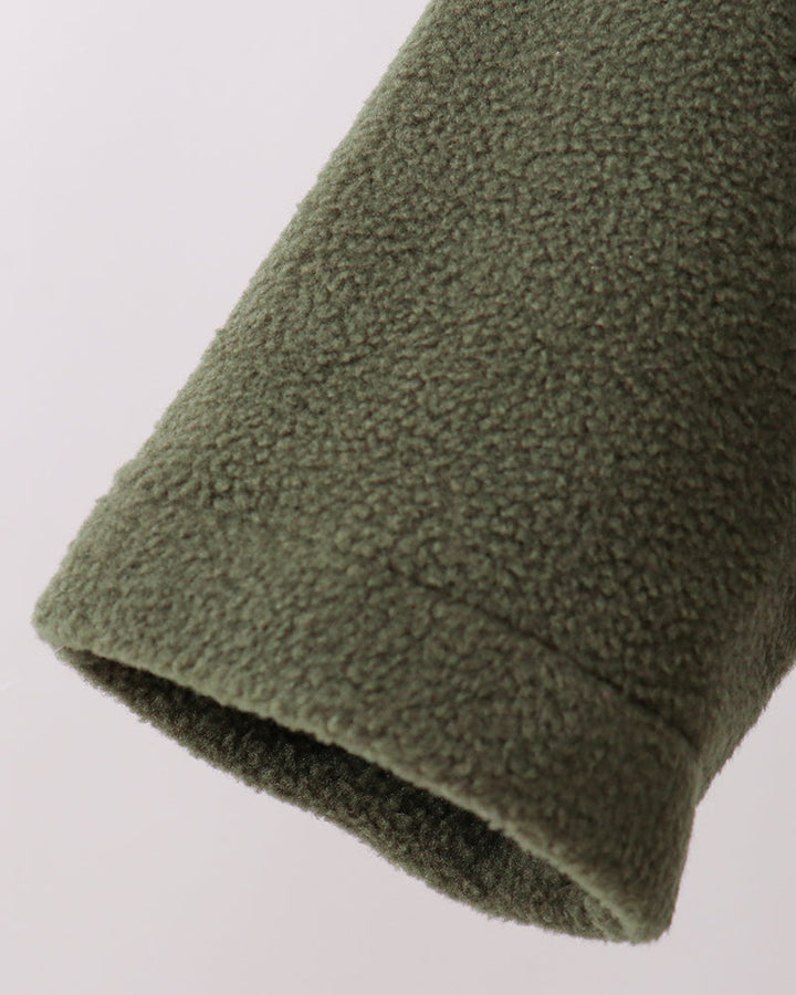 Dark green fleece coat sleeve hem with soft textured pile and ribbed cuff
