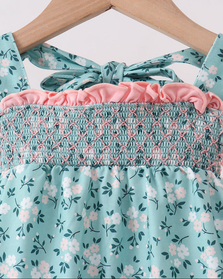 Green floral smocked dress neckline with ruffle trim and bow, close-up