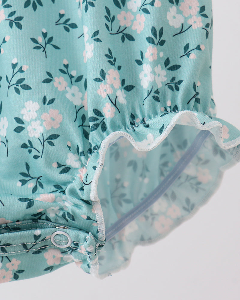 Turquoise floral bubble romper with scalloped ruffle leg openings and elastic waist