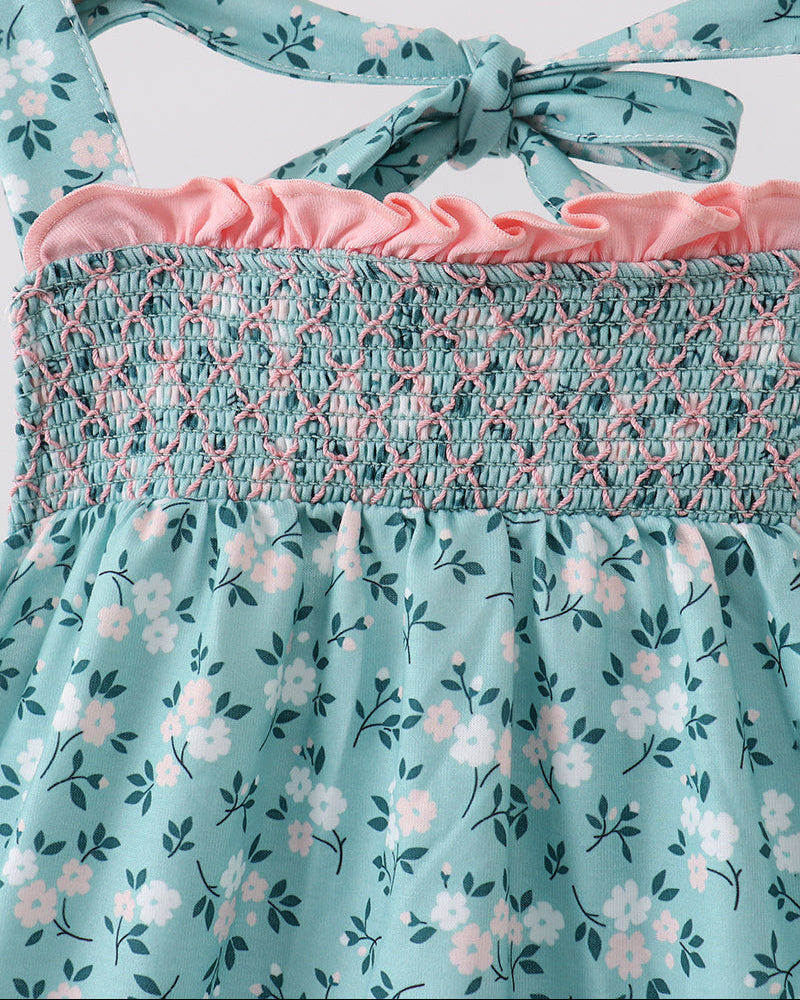 Teal floral smocked top with knotted bow at neckline