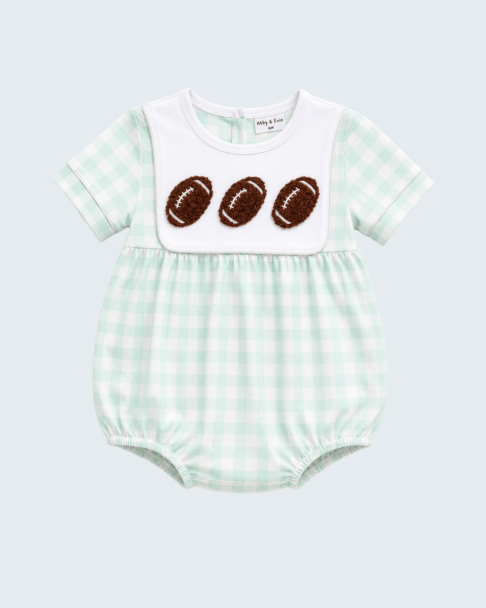 Green gingham bubble romper with white bib and three football appliqués