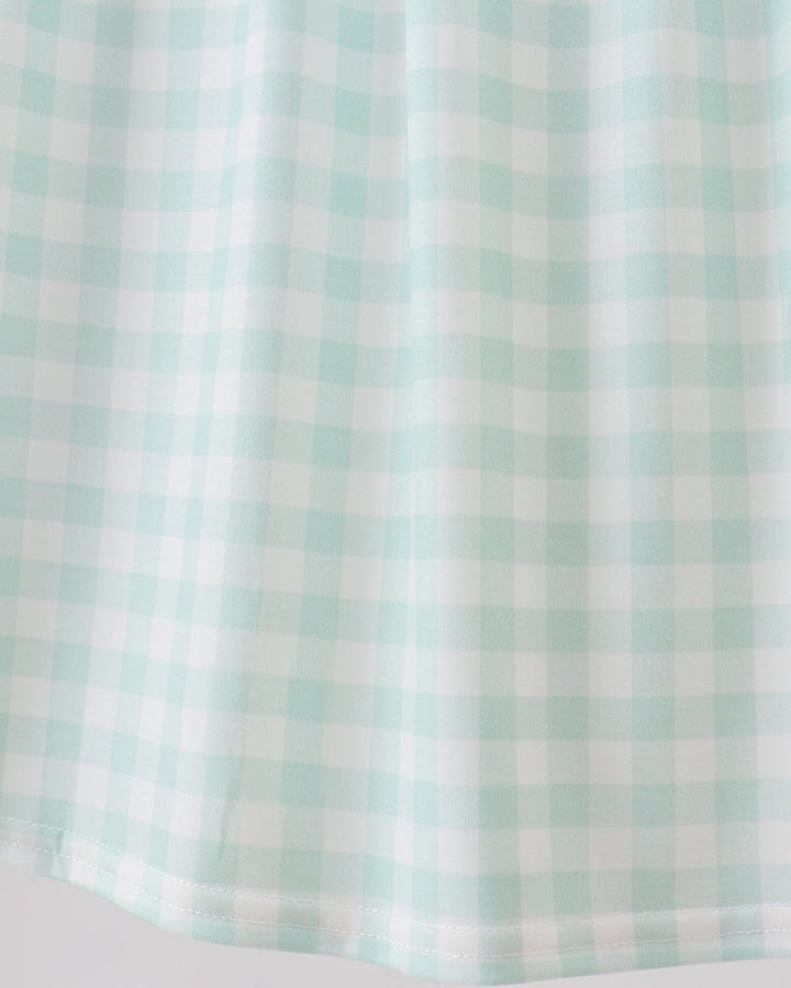 A close-up of a mint green and white gingham checkered fabric, showing the texture and pattern of the checkered squares.