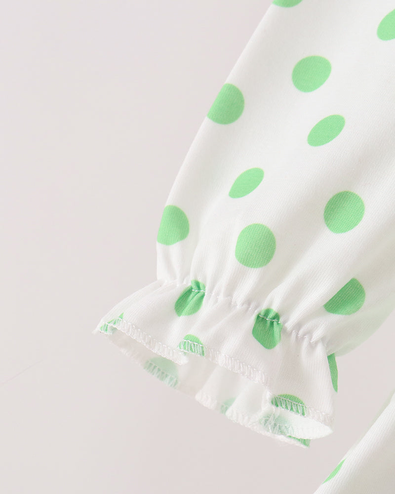 Gathered sleeve cuff on white dress with green polka dots and red trim