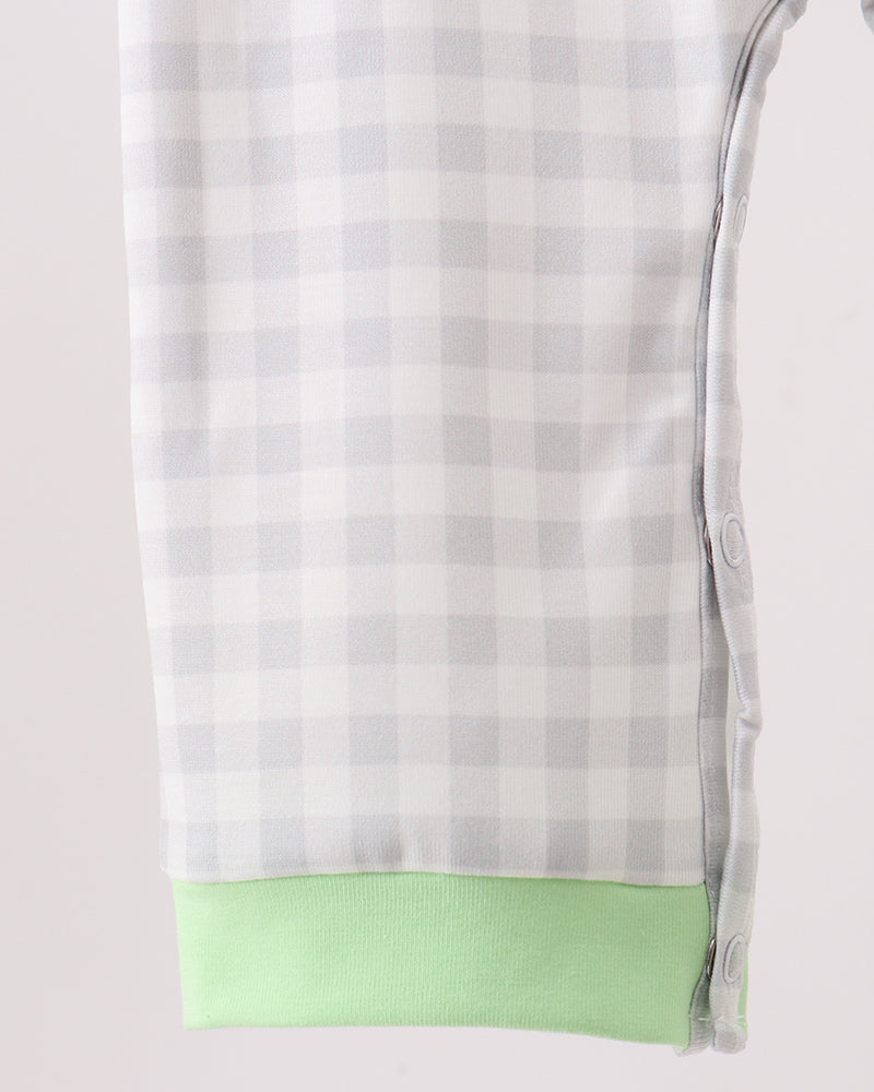 Light blue plaid romper with green hem and side button detail