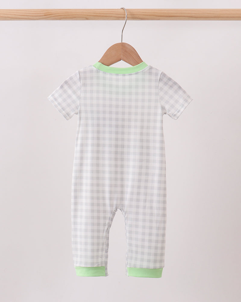 Light blue gingham romper with green neckline and leg cuffs, short sleeves