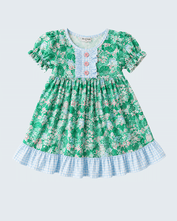 Green floral dress with checkered bottom on a light blue background