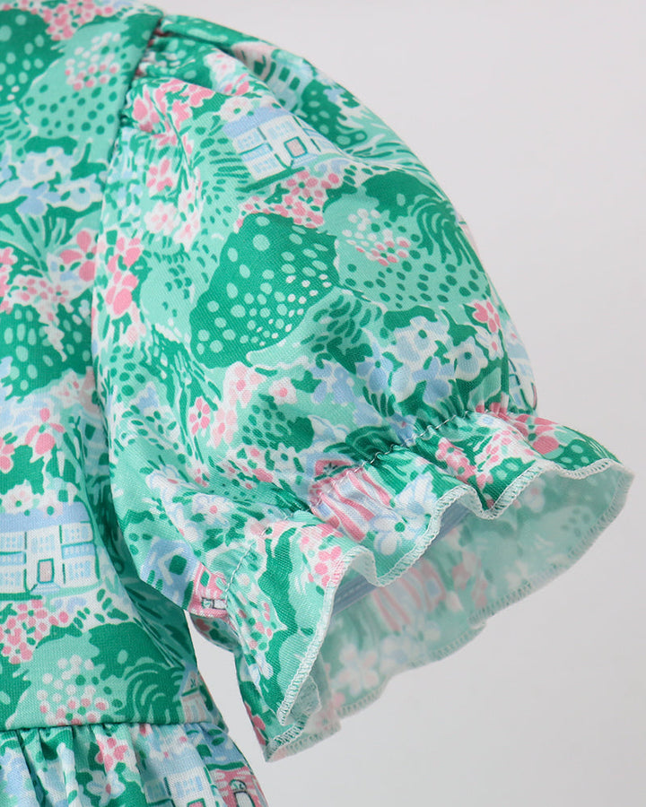 Green floral dress with ruffled hem on a white background