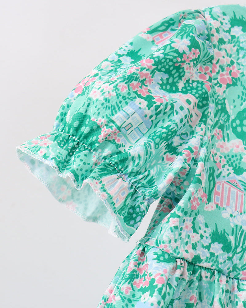 Green floral dress with ruffled sleeves on a light gray background