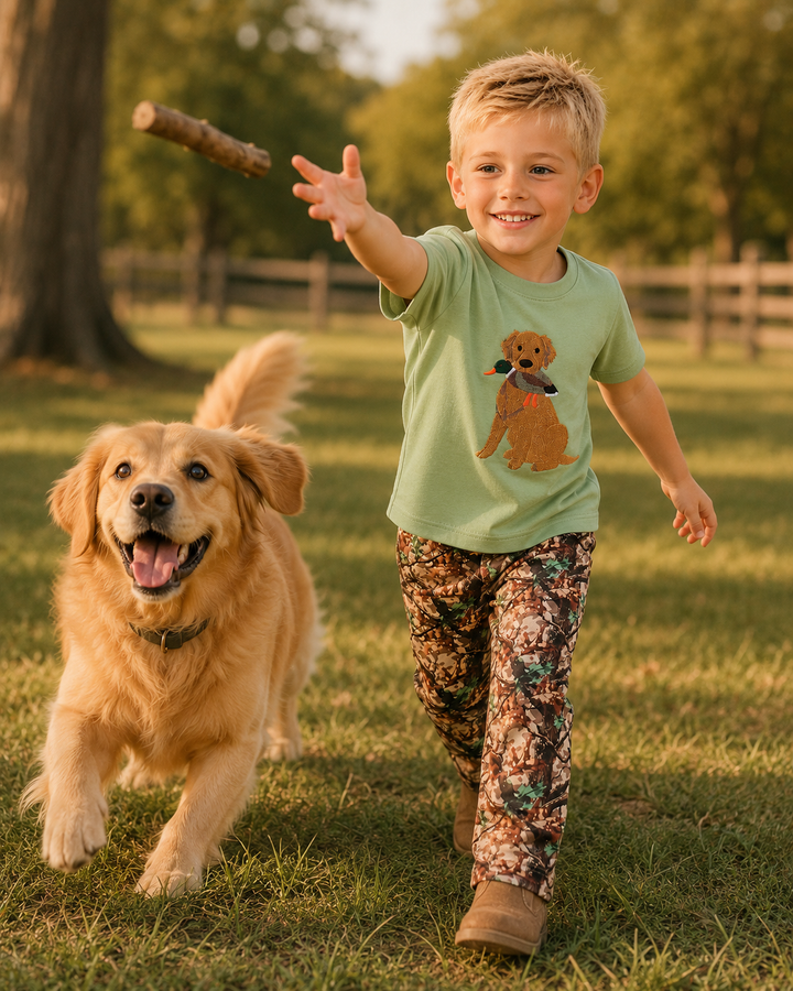 Young boy is throwing a stick to his dog