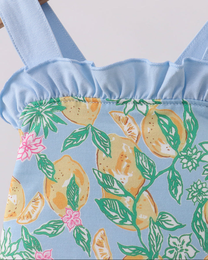 Close up of baby girl romper with lemon print
