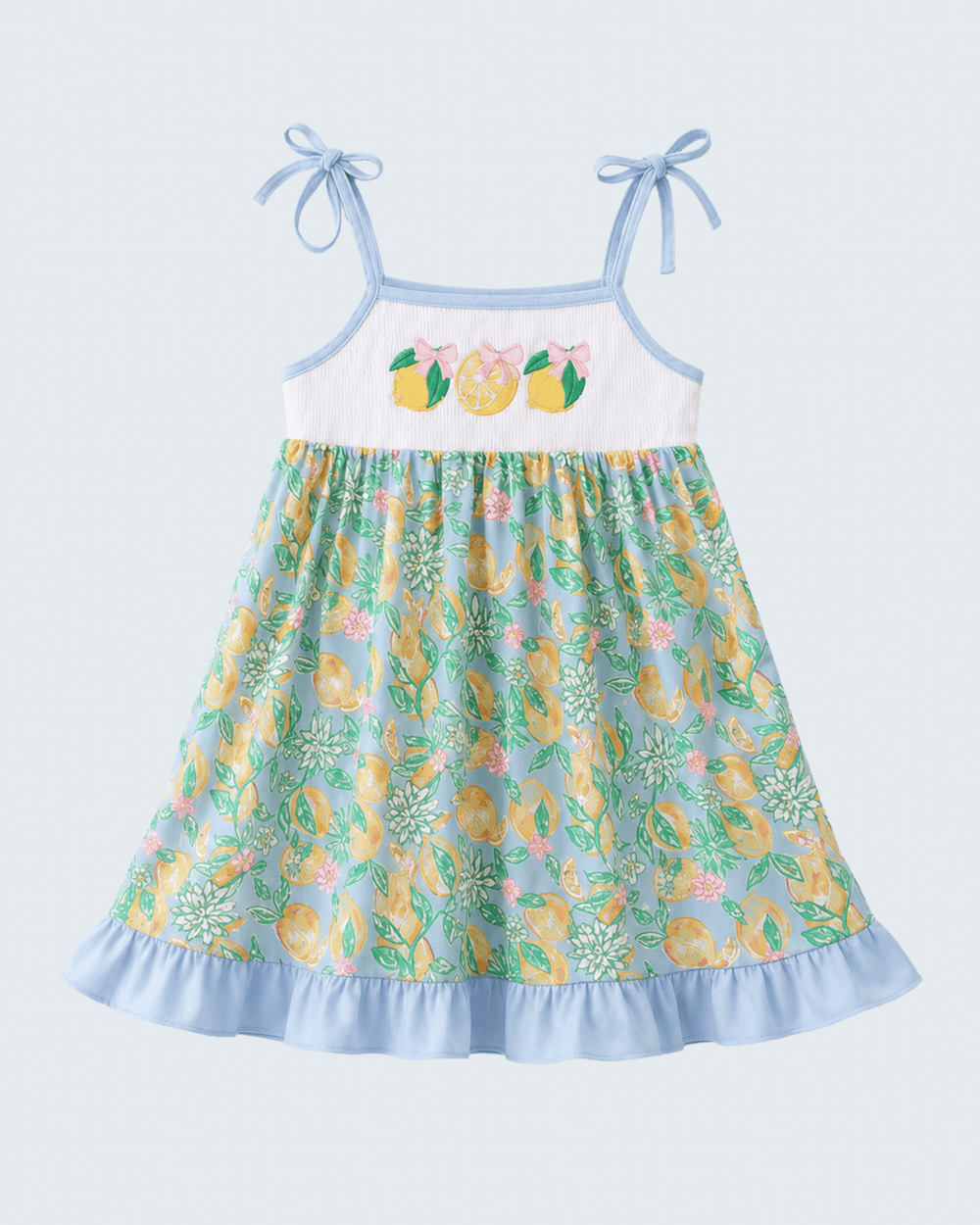 Children's dress with lemon pattern on a light blue background