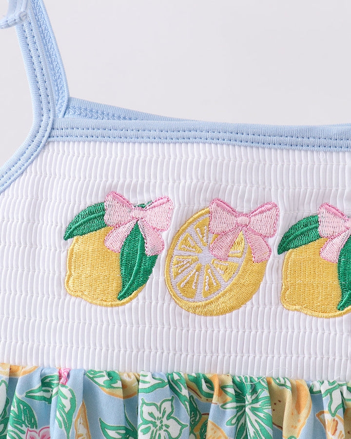 Close up of girls dress with lemon embroidery