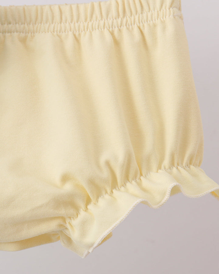 Cream baby bloomers with elastic waistband and ruffled leg hem detail