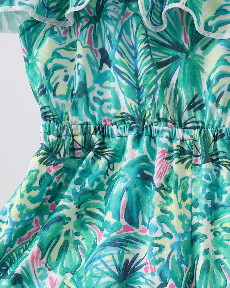 Green Lily floral jumpsuit close-up: teal floral leaf print with smocked elastic waist