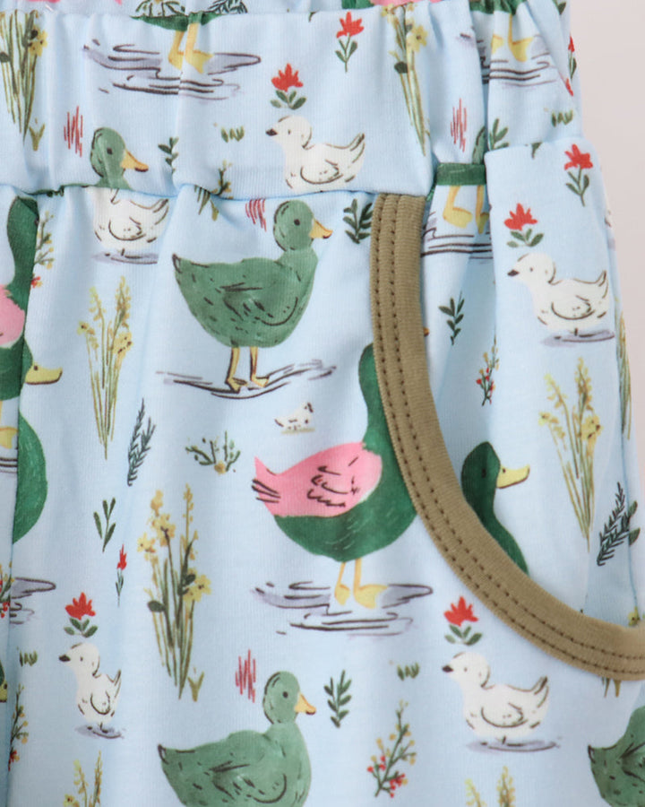 Bird-print pants with light blue base and multicolor duck artwork