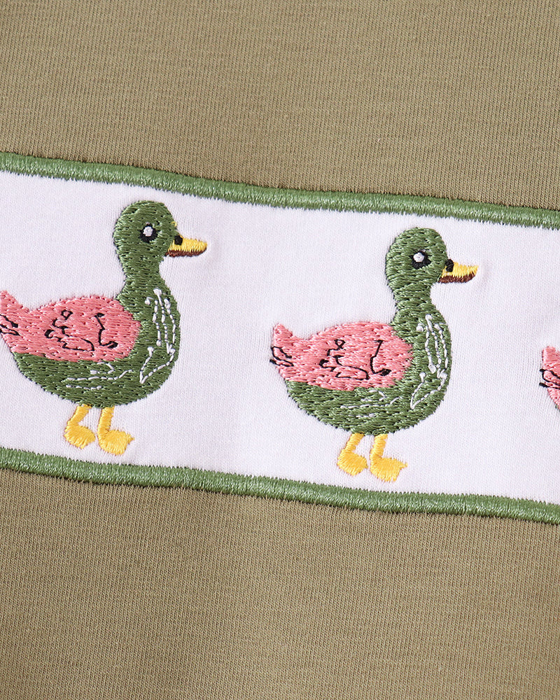 Bird-embroidered trim on waistband of light blue bird-print pajama pants
