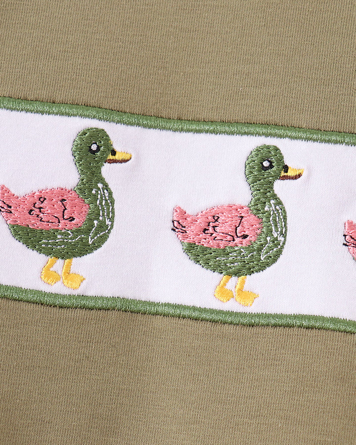 Bird-embroidered trim on waistband of light blue bird-print pajama pants